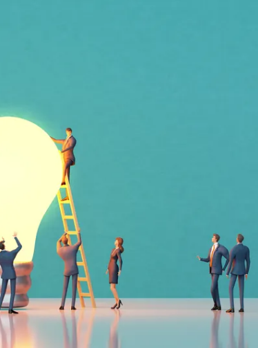 Professionals collaborating around a glowing lightbulb